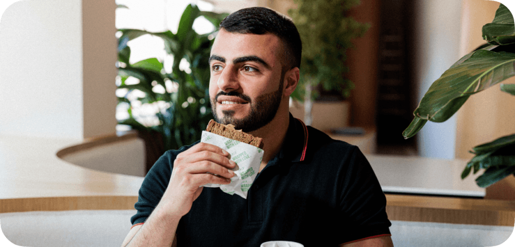 man eating calo sandwich